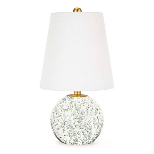 Small crystal table lamp with a white shade, brass fittings, and air bubbles within the crystal